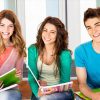 two-girls-and-one-boy-student-smiling-with-notebooks